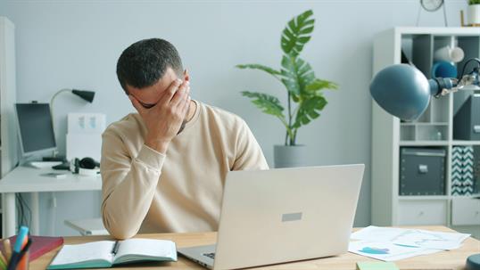 man at desk upset