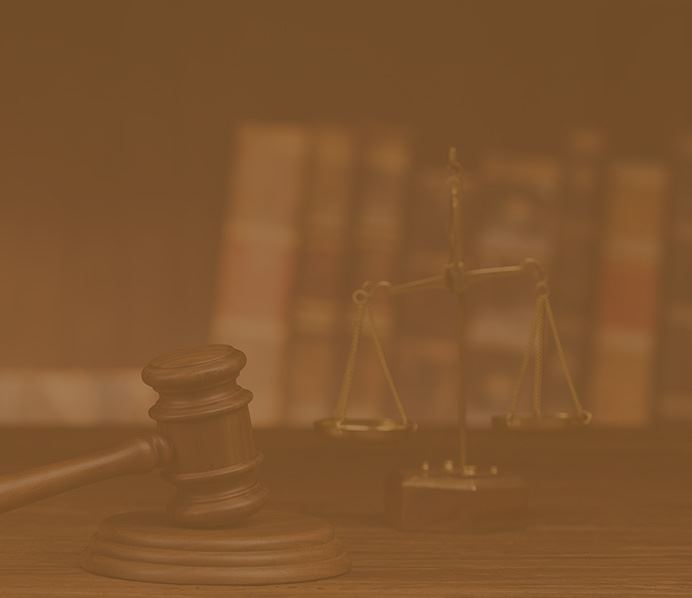 Gavel and justice scales in front of employment law books